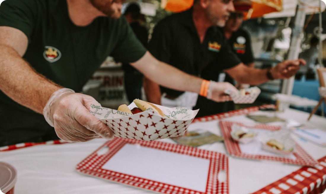 Char-Hut catering crew serving food at an outdoor event